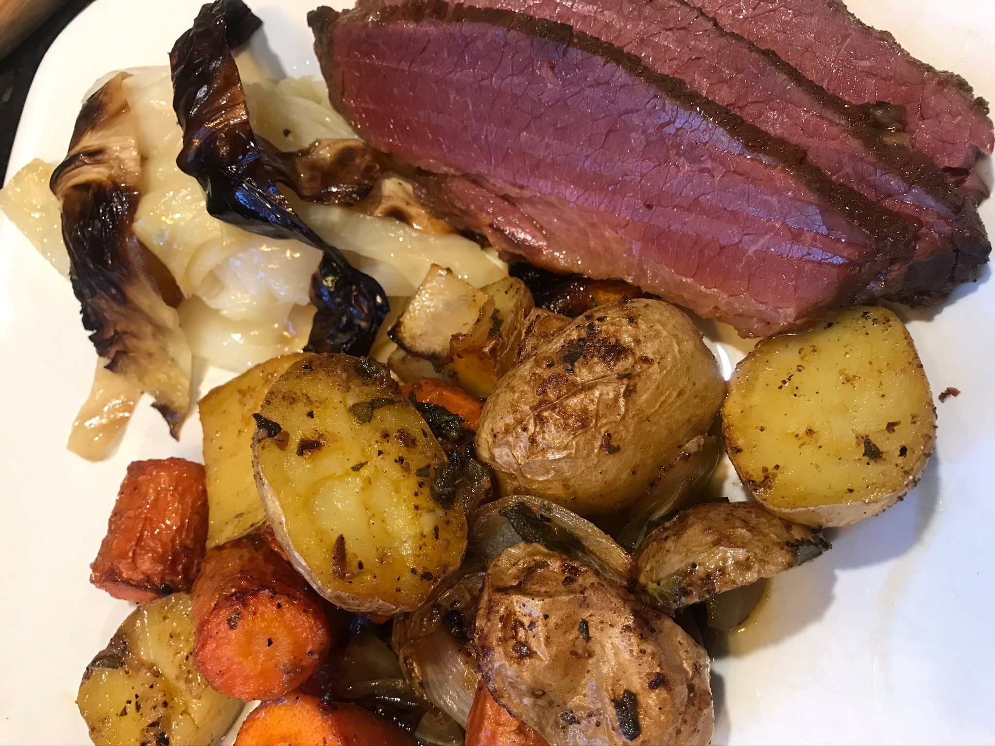 Braised corn beef, grilled cabbage, roasted carrots and potatoes